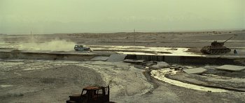Movie still from “The Kite Runner” (2007), directed by Marc Forster – A truck is driving through a puddle of water; Extreme Wide shot, High angle