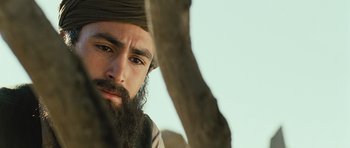 Movie still from “The Kite Runner” (2007), directed by Marc Forster – A man with a beard is looking at the camera; Close Up shot, Low angle