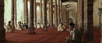 Movie still from “The Kite Runner” (2007), directed by Marc Forster – A group of men sitting on the floor of a building; Extreme Wide shot, High angle