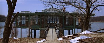 Movie still from “The Lake House” (2006), directed by Alejandro Agresti – Two people standing on a dock near a building; Extreme Wide shot, Low angle