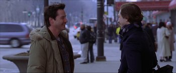 Movie still from “The Lake House” (2006), directed by Alejandro Agresti – Two men are talking on the sidewalk of a city street; Medium shot, Over the shoulder angle