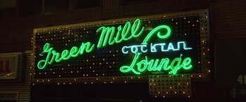 Movie still from “The Lake House” (2006), directed by Alejandro Agresti – A neon sign that reads " green mill cocktail lounge "; Wide shot, Low angle