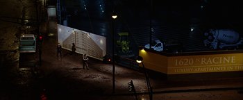 Movie still from “The Lake House” (2006), directed by Alejandro Agresti – A man standing in a dark room next to a building; Extreme Wide shot, High angle