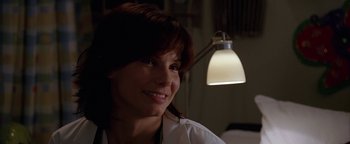 Movie still from “The Lake House” (2006), directed by Alejandro Agresti – A woman in a white lab coat smiling at the camera; Close Up shot, Over the shoulder angle