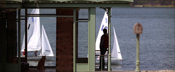 Movie still from “The Lake House” (2006), directed by Alejandro Agresti – A man standing on a balcony looking out at the water; Extreme Wide shot, Low angle