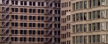Movie still from “The Lake House” (2006), directed by Alejandro Agresti – A fire escape on the side of a building; Extreme Wide shot, High angle