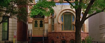 Movie still from “The Lake House” (2006), directed by Alejandro Agresti – A building with a door and window on the side of the building; Extreme Wide shot, Low angle