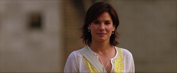 Movie still from “The Lake House” (2006), directed by Alejandro Agresti – A person wearing a white and yellow shirt; Close Up shot, Low angle