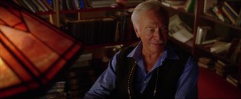 Movie still from “The Lake House” (2006), directed by Alejandro Agresti – An older man wearing a blue shirt and a black vest; Close Up shot, Over the shoulder angle