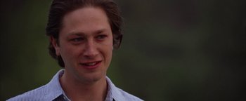 Movie still from “The Lake House” (2006), directed by Alejandro Agresti – A man's face with a green background; Close Up shot, Over the shoulder angle