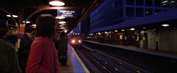 Movie still from “The Lake House” (2006), directed by Alejandro Agresti – People waiting for a train at a train station at night; Wide shot, Over the shoulder angle