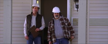 Movie still from “The Lake House” (2006), directed by Alejandro Agresti – Two construction workers standing in front of a house; Medium shot, Low angle