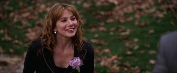 Movie still from “The Lake House” (2006), directed by Alejandro Agresti – A woman smiling with a flower in her hand; Close Up shot, Over the shoulder angle