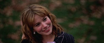 Movie still from “The Lake House” (2006), directed by Alejandro Agresti – A beautiful young lady smiling for the camera; Close Up shot, Over the shoulder angle