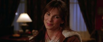 Movie still from “The Lake House” (2006), directed by Alejandro Agresti – A person smiling for the camera; Close Up shot, Over the shoulder angle