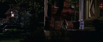 Movie still from “The Lake House” (2006), directed by Alejandro Agresti – Two people standing in front of a building at night; Extreme Wide shot, High angle