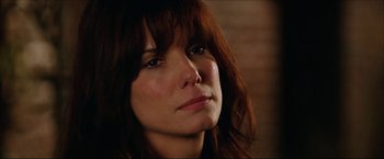 Movie still from “The Lake House” (2006), directed by Alejandro Agresti – A woman's face in a dark room; Close Up shot, Over the shoulder angle