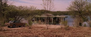 Movie still from “The Lake House” (2006), directed by Alejandro Agresti – A building that has been built on the side of a river; Extreme Wide shot, High angle