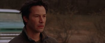 Movie still from “The Lake House” (2006), directed by Alejandro Agresti – A man in a brown jacket is looking to his left; Close Up shot, Over the shoulder angle