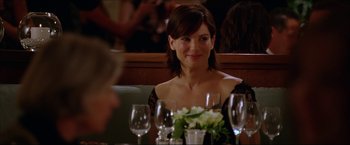 Movie still from “The Lake House” (2006), directed by Alejandro Agresti – A woman sitting in front of a table with wine glasses on it; Close Up shot, Over the shoulder angle