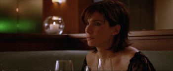 Movie still from “The Lake House” (2006), directed by Alejandro Agresti – A woman sitting at a table with a glass of wine in front of her; Close Up shot, Over the shoulder angle