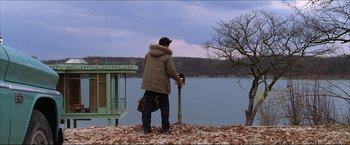 Movie still from “The Lake House” (2006), directed by Alejandro Agresti – A man standing on a hill looking at a body of water; Wide shot, Low angle