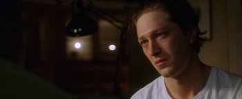 Movie still from “The Lake House” (2006), directed by Alejandro Agresti – A person wearing a white t - shirt; Close Up shot, Over the shoulder angle