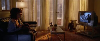 Movie still from “The Lake House” (2006), directed by Alejandro Agresti – A living room filled with furniture next to a large window; Wide shot, High angle