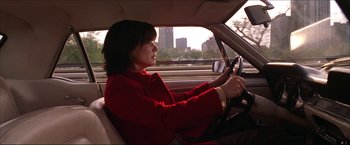 Movie still from “The Lake House” (2006), directed by Alejandro Agresti – A woman in a red jacket driving a car; Medium shot, Over the shoulder angle