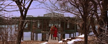 Movie still from “The Lake House” (2006), directed by Alejandro Agresti – Two people standing on a pier near a body of water; Extreme Wide shot, Low angle