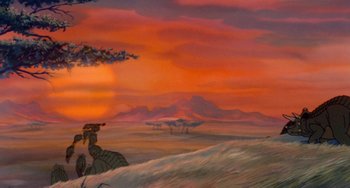Movie still from “The Land Before Time” (1988), directed by Don Bluth – An oil painting of an orange sky and a field; Extreme Wide shot, Low angle