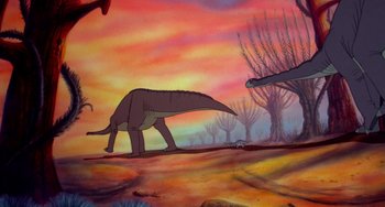 Movie still from “The Land Before Time” (1988), directed by Don Bluth – An illustration of an animal walking in a field; Wide shot, Low angle
