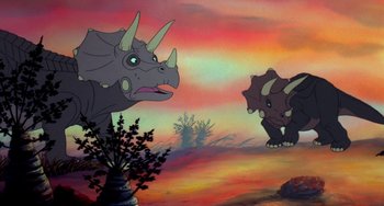 Movie still from “The Land Before Time” (1988), directed by Don Bluth – A painting of two triceratops in a field; Wide shot, Low angle