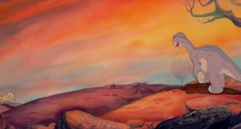 Movie still from “The Land Before Time” (1988), directed by Don Bluth – A painting of an orange sky with a bird flying above it; Wide shot, Low angle