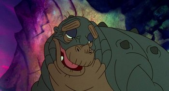 Movie still from “The Land Before Time” (1988), directed by Don Bluth – An animated hippopotamus is smiling for the camera; Close Up shot, High angle
