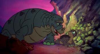 Movie still from “The Land Before Time” (1988), directed by Don Bluth – A large and a small turtle are in a rocky area; Wide shot, High angle