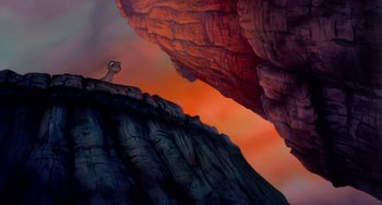 Movie still from “The Land Before Time” (1988), directed by Don Bluth – A painting of a lion standing on top of a cliff; Extreme Wide shot, Low angle
