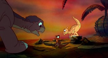 Movie still from “The Land Before Time” (1988), directed by Don Bluth – An animated scene of a cat and a dog chasing each other; Wide shot, High angle