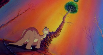 Movie still from “The Land Before Time” (1988), directed by Don Bluth – A painting of a dinosaur and a tree; Wide shot, Low angle
