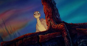 Movie still from “The Land Before Time” (1988), directed by Don Bluth – A character from the land before time; Medium shot, Low angle