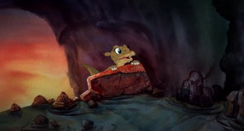 Movie still from “The Land Before Time” (1988), directed by Don Bluth – A painting of an animal sitting on top of a rock; Wide shot, High angle