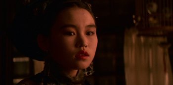 Movie still from “The Last Emperor” (1987), directed by Bernardo Bertolucci – A young woman with a red lipstick on her lips; Close Up shot, Low angle