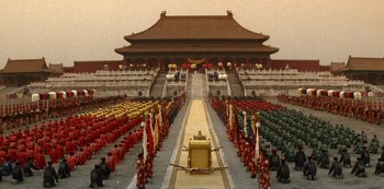 Movie still from “The Last Emperor” (1987), directed by Bernardo Bertolucci – A large group of people standing in front of a building; Extreme Wide shot, High angle