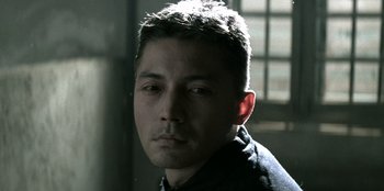 Movie still from “The Last Emperor” (1987), directed by Bernardo Bertolucci – A person wearing a black shirt; Close Up shot, Low angle