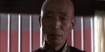 Movie still from “The Last Emperor” (1987), directed by Bernardo Bertolucci – A man with a shaved head and a bald head; Close Up shot, Low angle