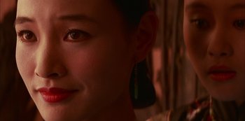 Movie still from “The Last Emperor” (1987), directed by Bernardo Bertolucci – A woman's face with a smile on her face; Close Up shot, Over the shoulder angle