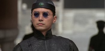 Movie still from “The Last Emperor” (1987), directed by Bernardo Bertolucci – A man wearing a hat and sunglasses; Close Up shot, Low angle