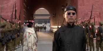 Movie still from “The Last Emperor” (1987), directed by Bernardo Bertolucci – A man and a woman dressed in traditional chinese garb; Close Up shot, Low angle