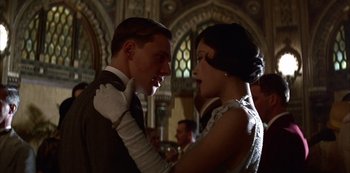 Movie still from “The Last Emperor” (1987), directed by Bernardo Bertolucci – A man and a woman are dancing together; Close Up shot, Low angle