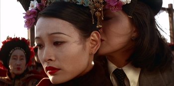 Movie still from “The Last Emperor” (1987), directed by Bernardo Bertolucci – A person wearing a hat; Close Up shot, Over the shoulder angle